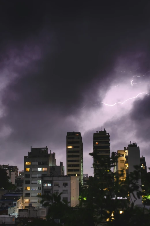 an image of a storm coming from behind a city building