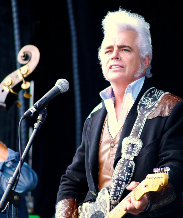 a person playing the guitar at an event