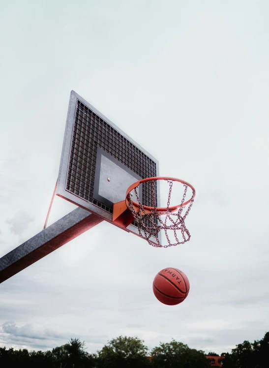 a basketball is going into the net outside