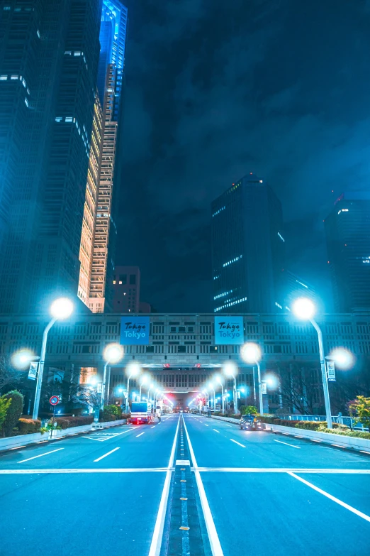 a road with lights along side a large city building