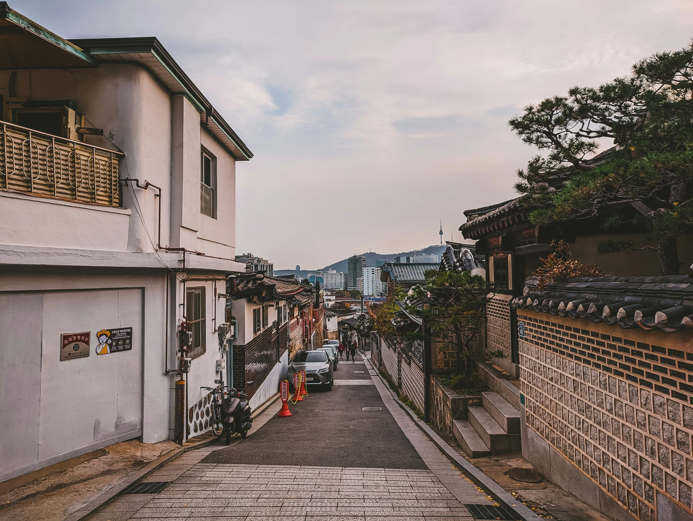 street with cars and people on the sidewalks