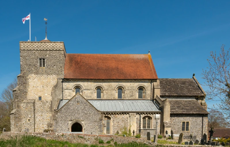 an old church with a steeple in the background