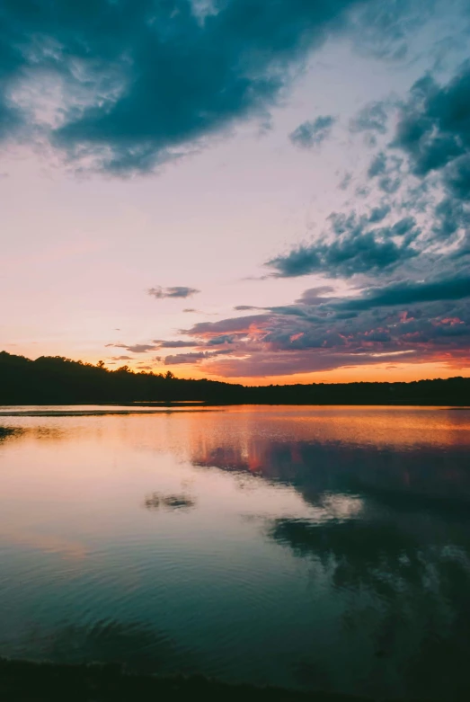 water on the ground, with a sky covered in clouds