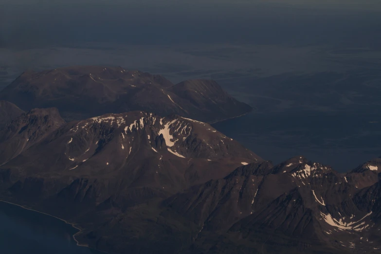 a view from a jet, on which is a view of a mountain range and lake