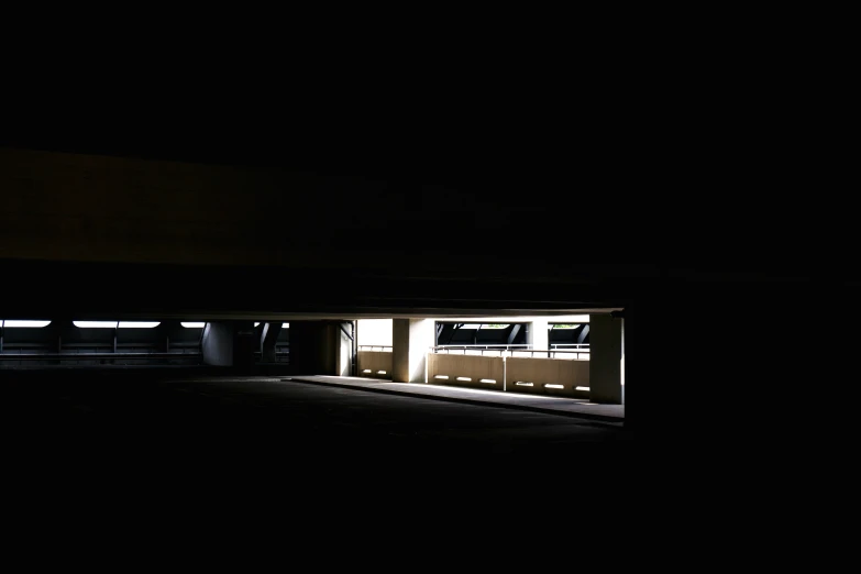 the dark view of a dark parking garage with doors open at night