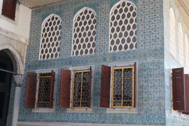 there are four windows in this ornately decorated wall
