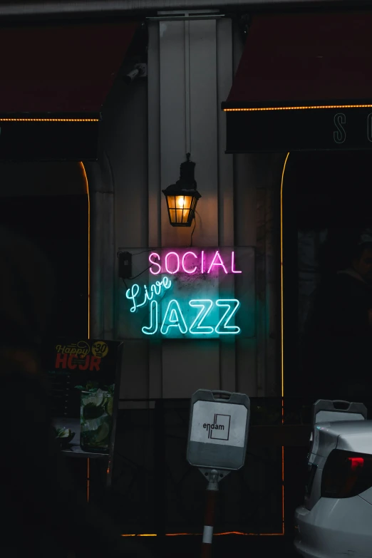 a neon sign advertising a bar called social jazz