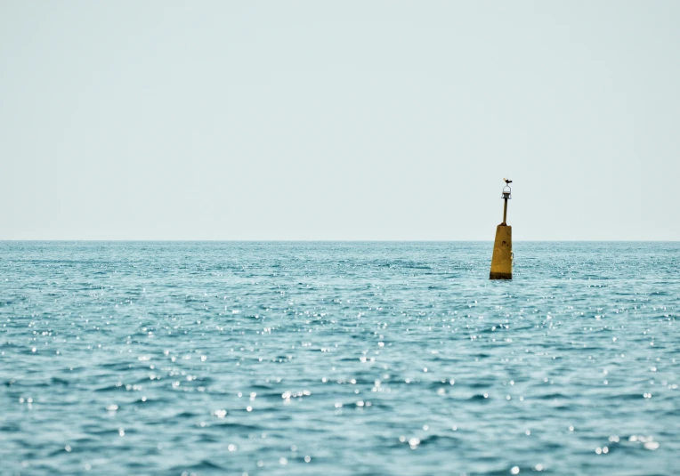 a lighthouse on a small block in the water