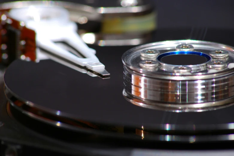 a silver hard drive on the table with other instruments