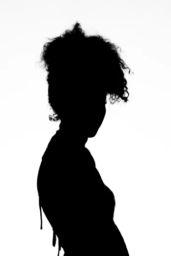 a pregnant woman's silhouette against a gray background