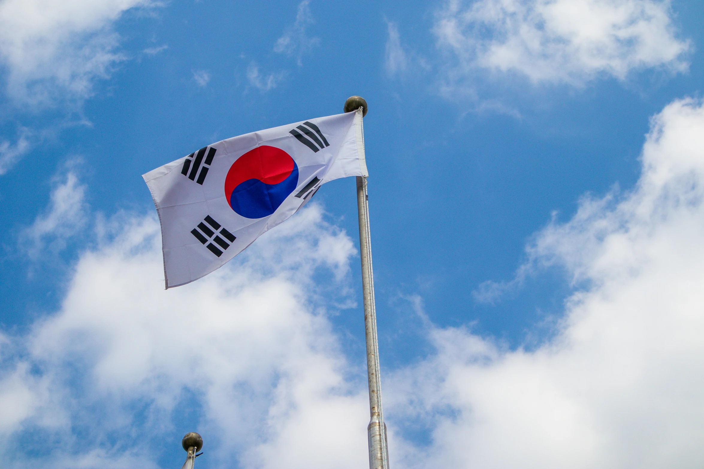 a flag flies in the wind on a cloudy day