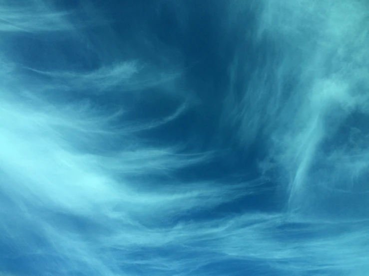 an airplane is flying in a clear blue sky