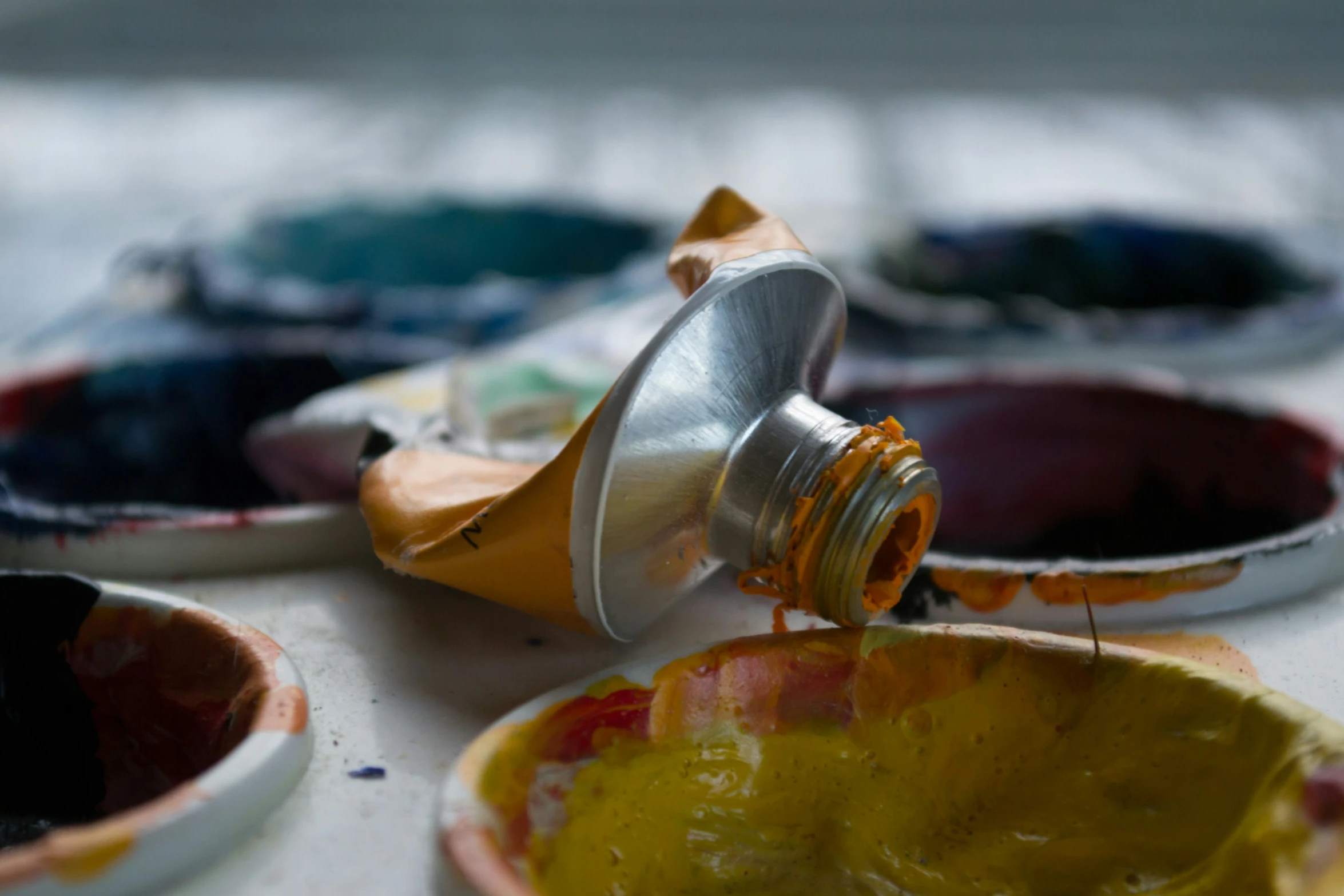 a jar of orange colored liquid being filled by someone