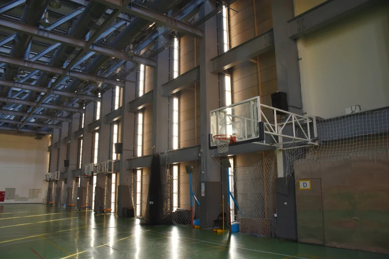 a metal structure with several windows and a cage hanging in the center