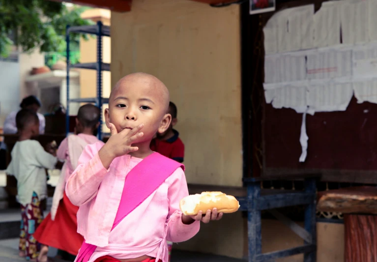 there is a child that has a pastry in hand