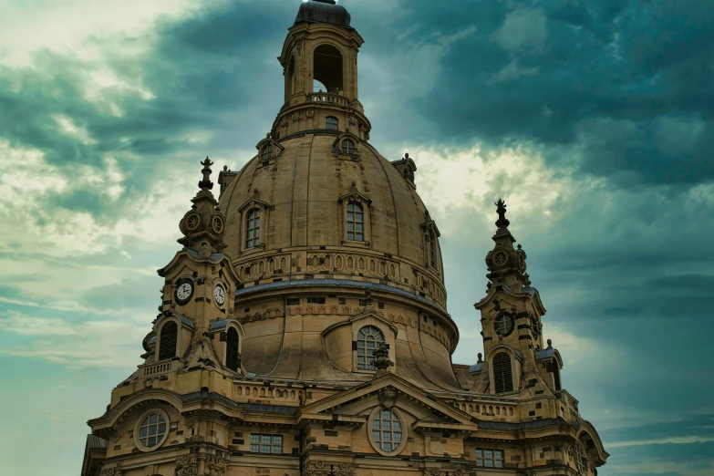 a clock tower that is against a cloudy sky