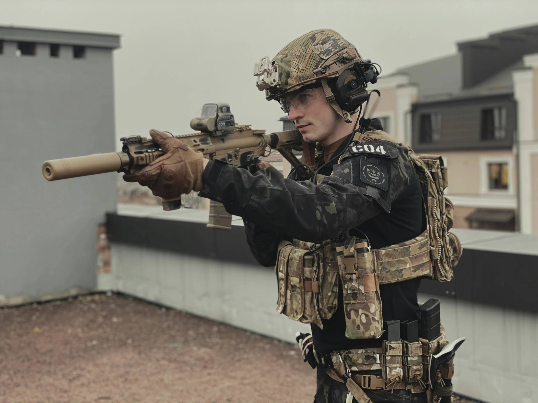 soldier in camouflage holding a rifle on the roof