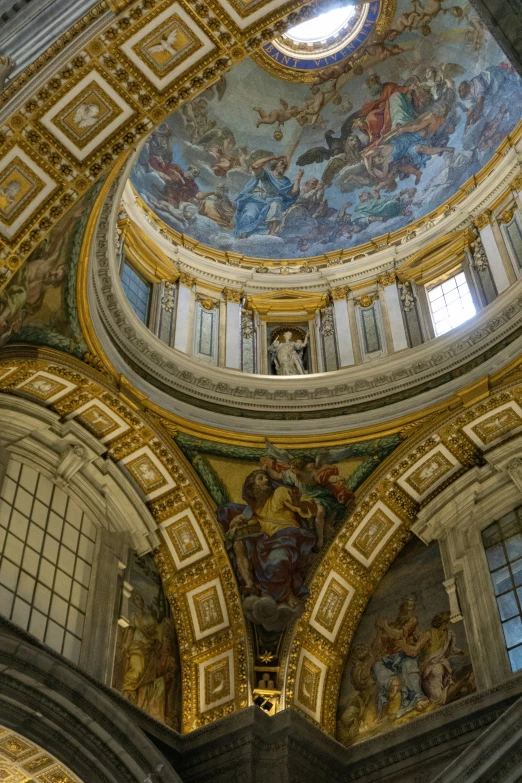 the interior of an old building with paintings on the ceiling