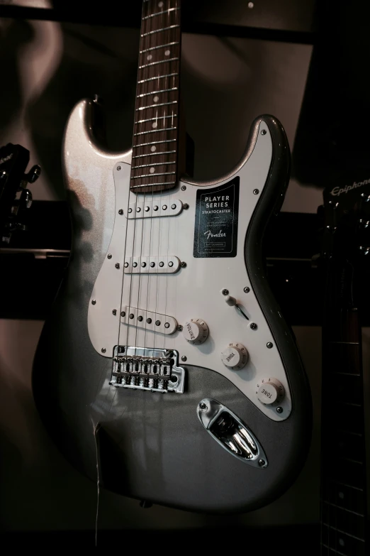 an electric guitar with a silver neck and pick up on it