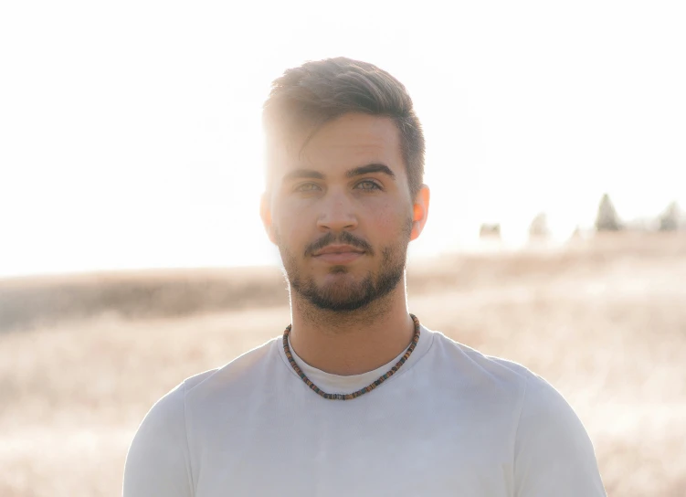 a man with a short beard and white shirt