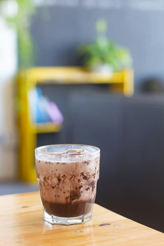 a glass on top of a wooden table