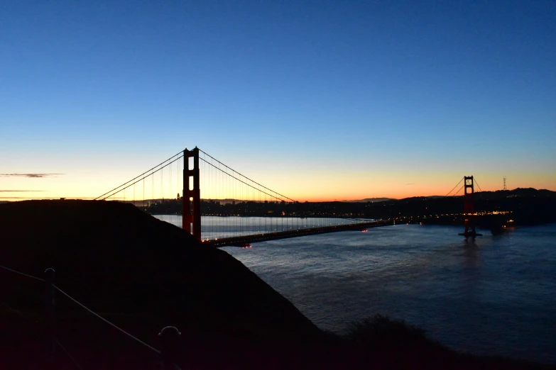 a very pretty view of a suspension bridge at dusk