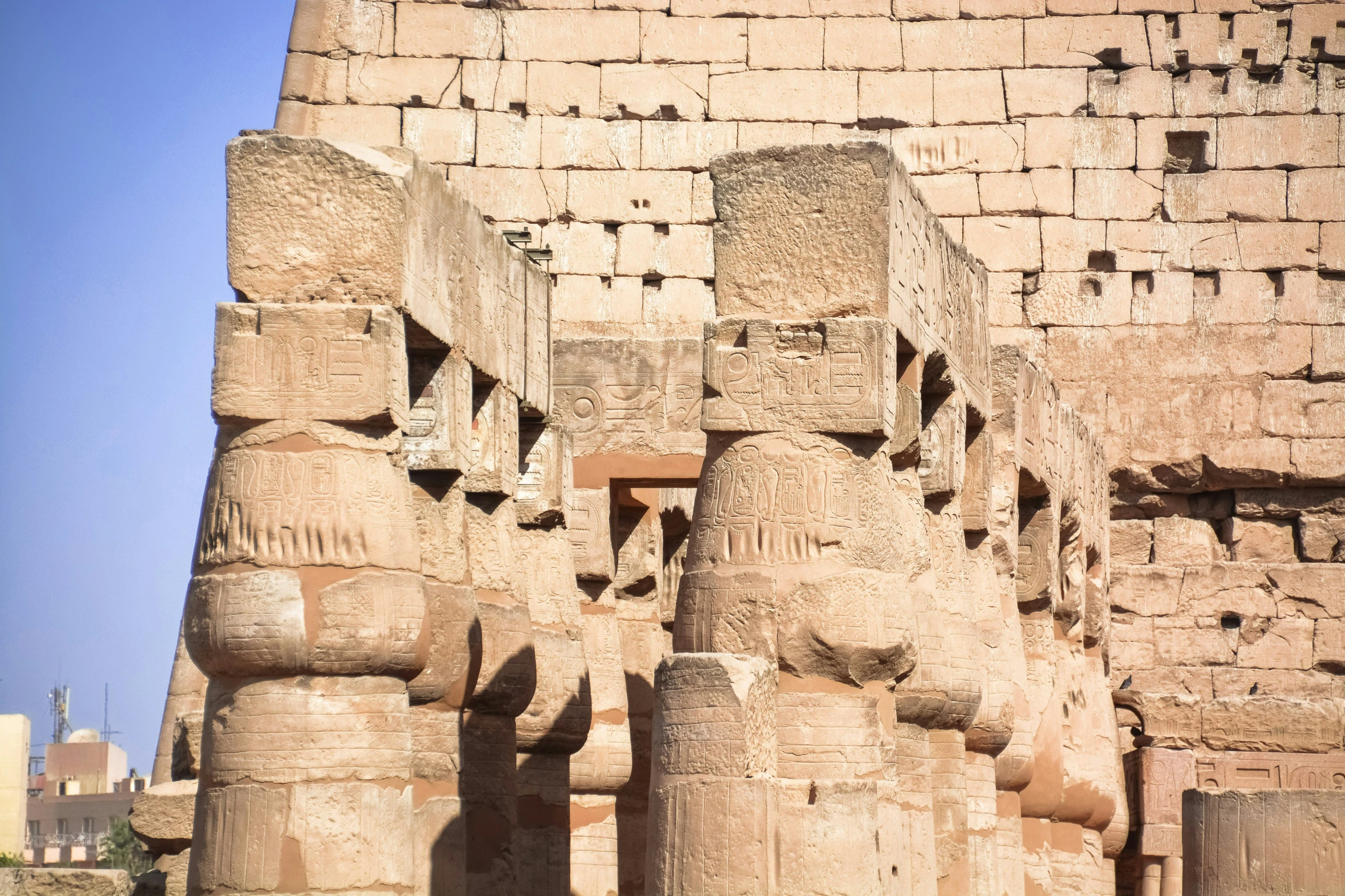 statues in a stone building with a brick wall