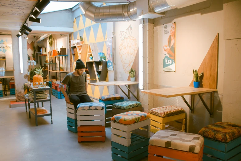 a person sitting on a bench surrounded by boxes of furniture