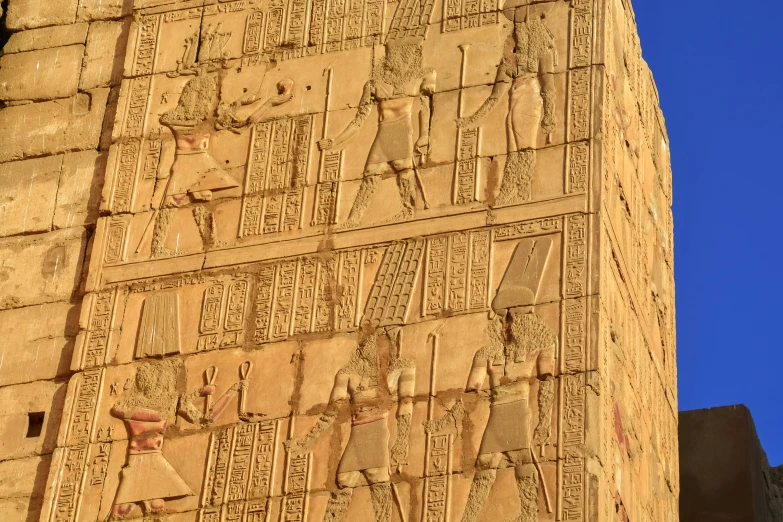 the side of a building with egyptian writing on it