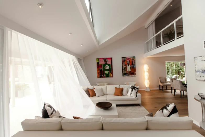 a modern living room with all white furniture and curtains