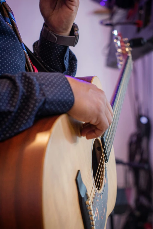 a man holding his guitar in his hands