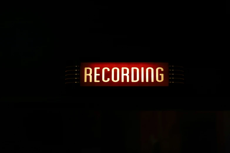 the sign on the building says recording