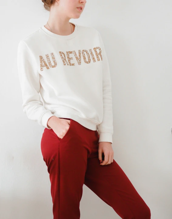 a girl in a sweater with writing on it