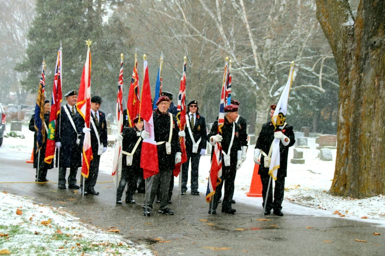 a group of men in uniforms holding flags