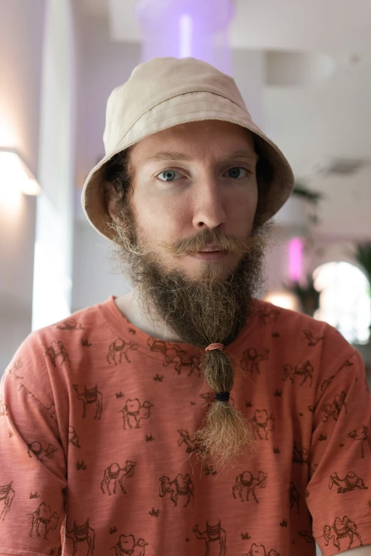 man with a hat on his head wearing an elephant print t - shirt