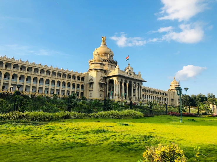 a big building with lots of windows near the grass