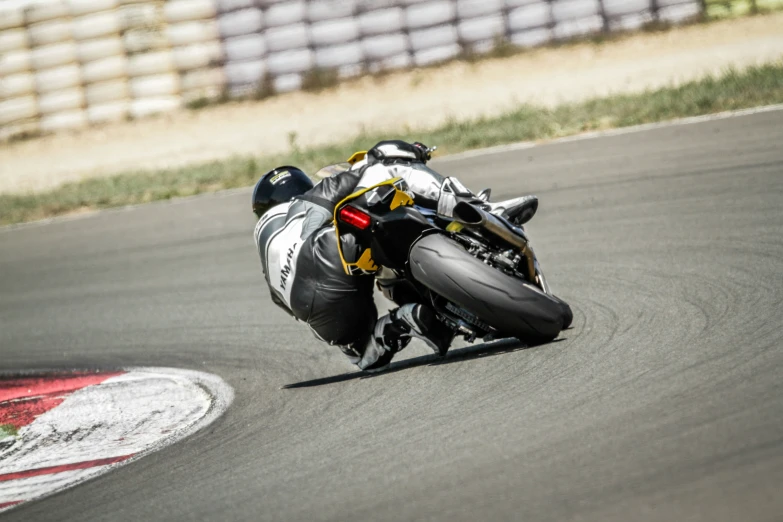 a motorcycle is rolling around the track with its racer