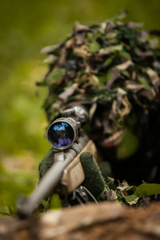 a close - up of a rifle with a camouflage wrapper