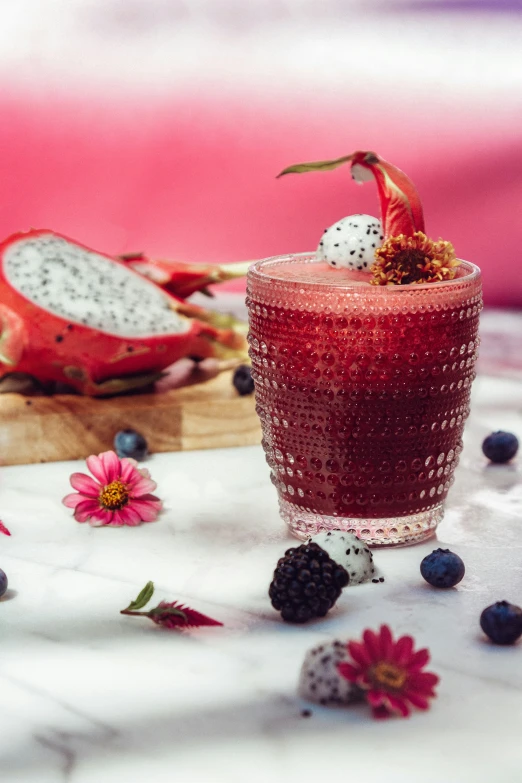 a glass with some fruit inside on a table