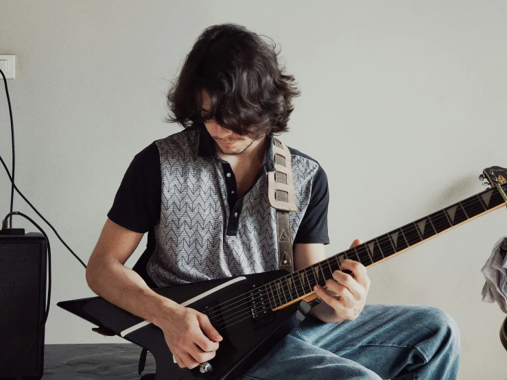 a man is playing a musical guitar in his living room