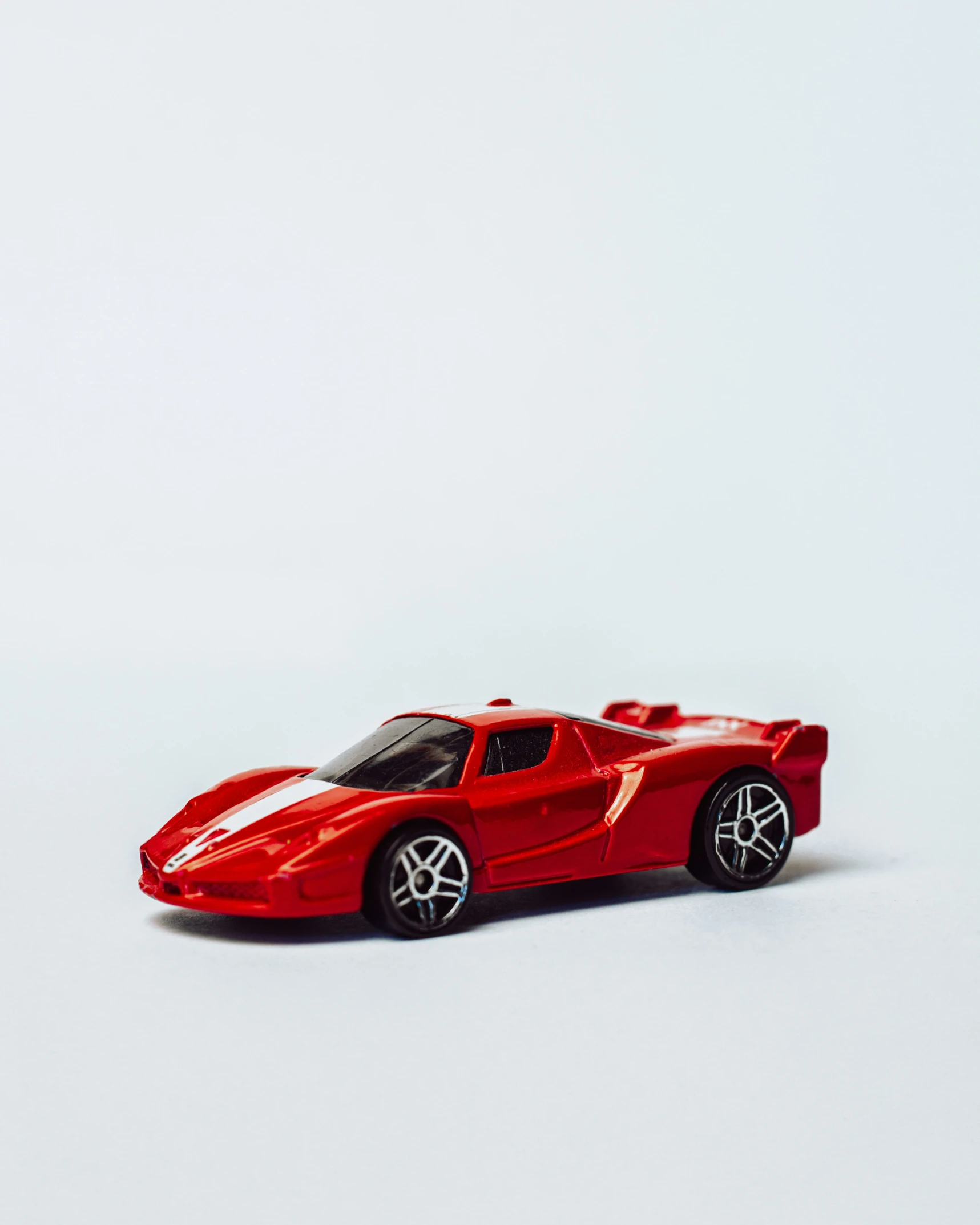 a toy red sports car in white background