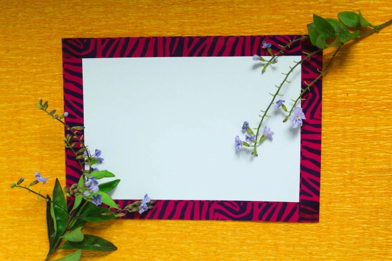 purple and red flowers on a colorful cloth and a white piece of paper