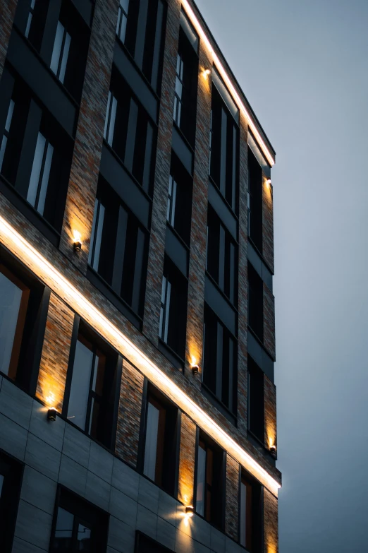 a very tall building with some windows and lights on