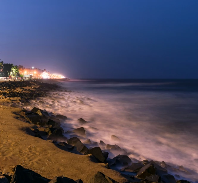 the coast is lit up by street lights at night