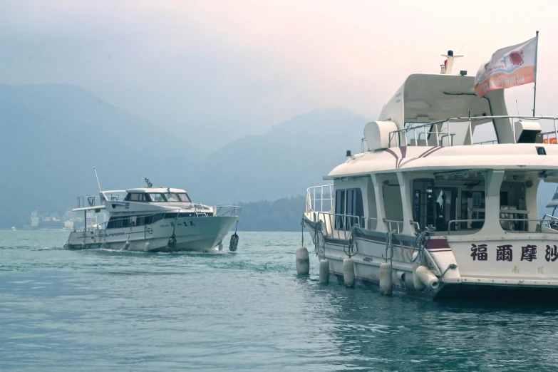 two boats sit next to each other on the water