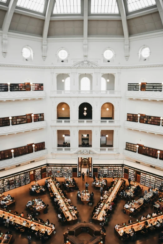a large liry with a spiral floored ceiling filled with books