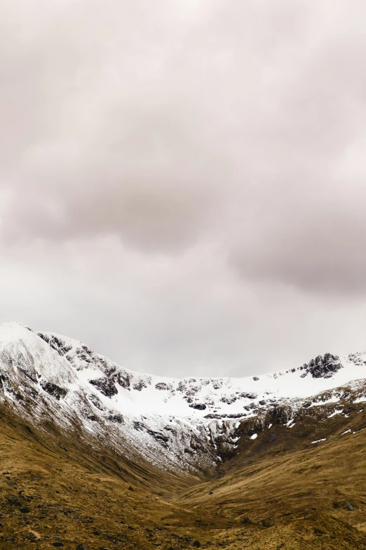 some big mountains are covered in snow and dirt