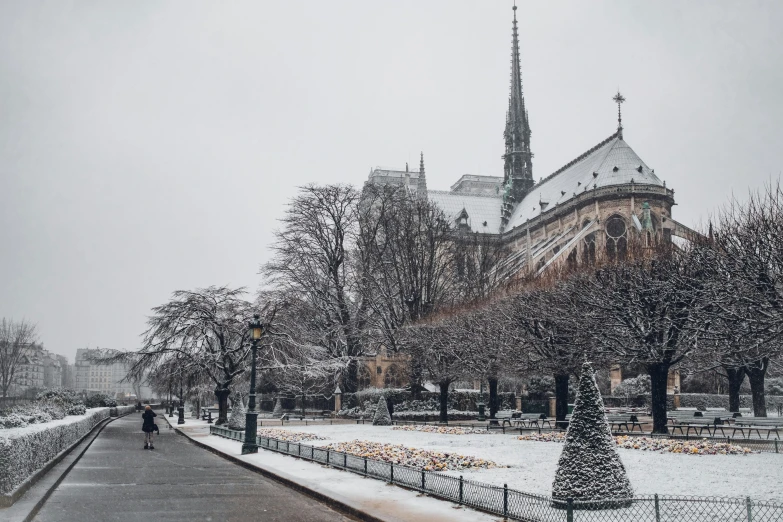 a long snow covered road leading to a large building