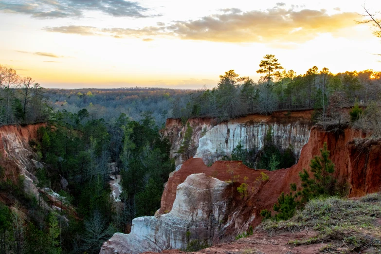 the sky in the background shows brown, yellow, and green cliffs