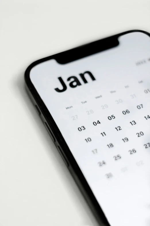 a close up of an iphone keyboard with a calendar on it